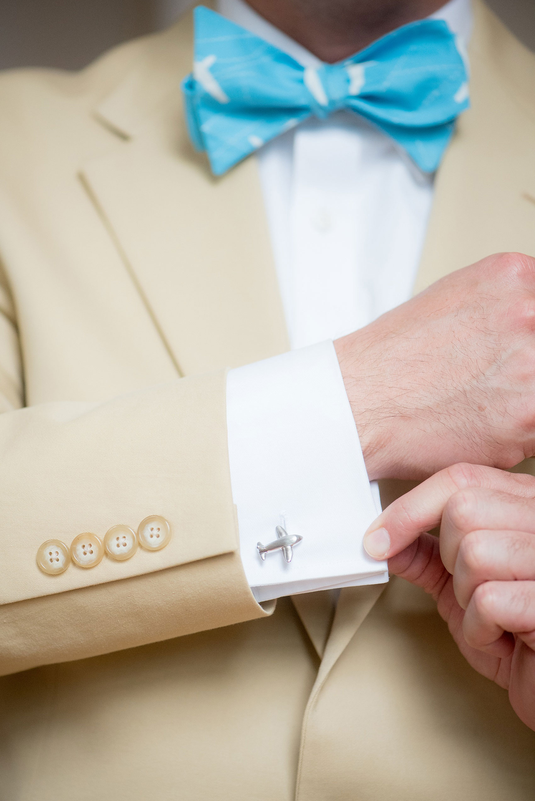 Mikkel Paige Photography wedding photos at The Merrimon-Wynne House in downtown Raleigh. A guest wearing North Carolina airplane cufflinks and blue bow tie.