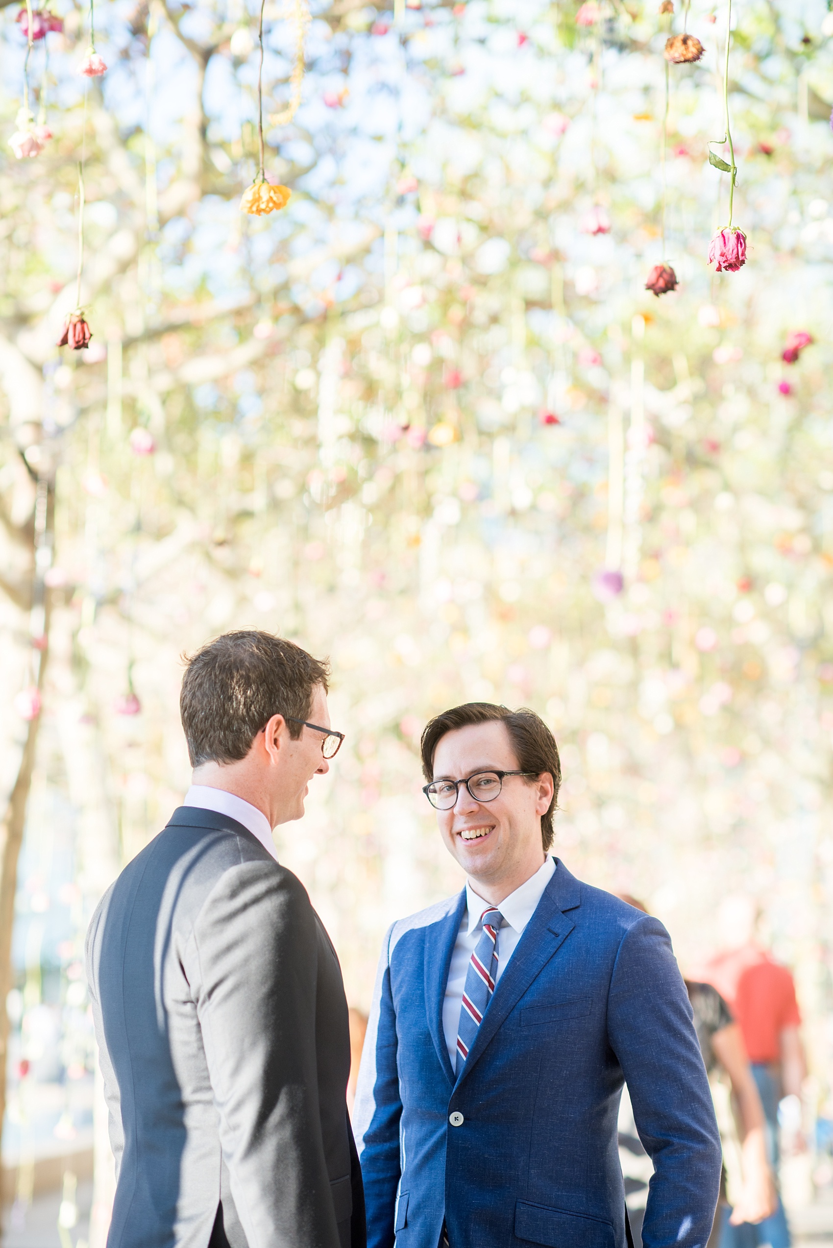 Mikkel Paige Photography photos of a same sex, gay engagement session in lower Manhattan's financial district with the grooms in custom suits.