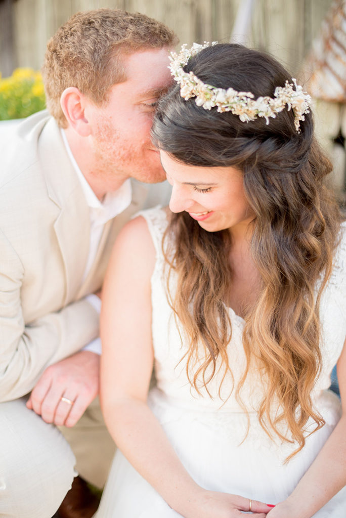 Mikkel Paige Photography photo of a rustic chic farm wedding at Spring Hill Manor, Maryland. Outdoor images of the bride and groom with the bride in a flower crown and v-neck lace gown.