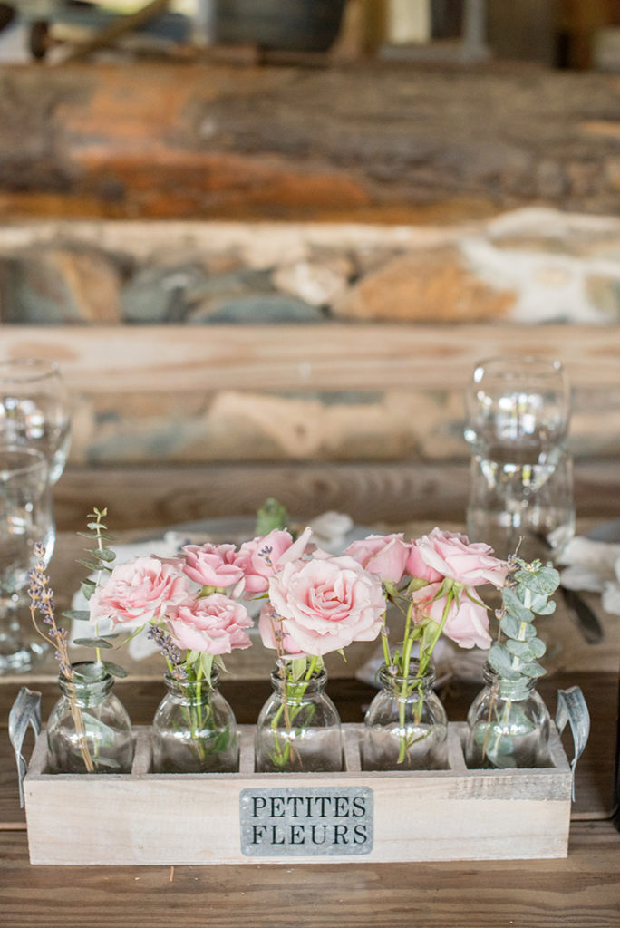 Mikkel Paige Photography photo of a rustic chic farm wedding at Spring Hill Manor, Maryland. Wood table detail with pink roses in bud vases.