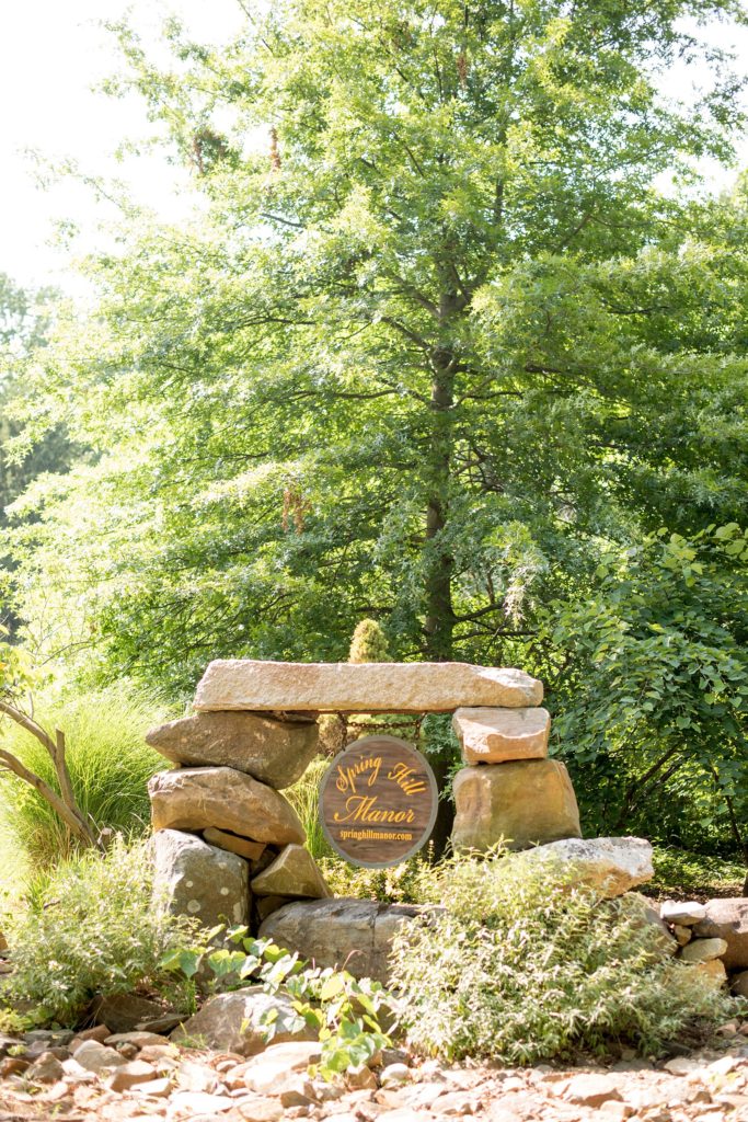 Mikkel Paige Photography photos of a wedding at Spring Hill Manor in Maryland. Photo of the farm's stone entryway.