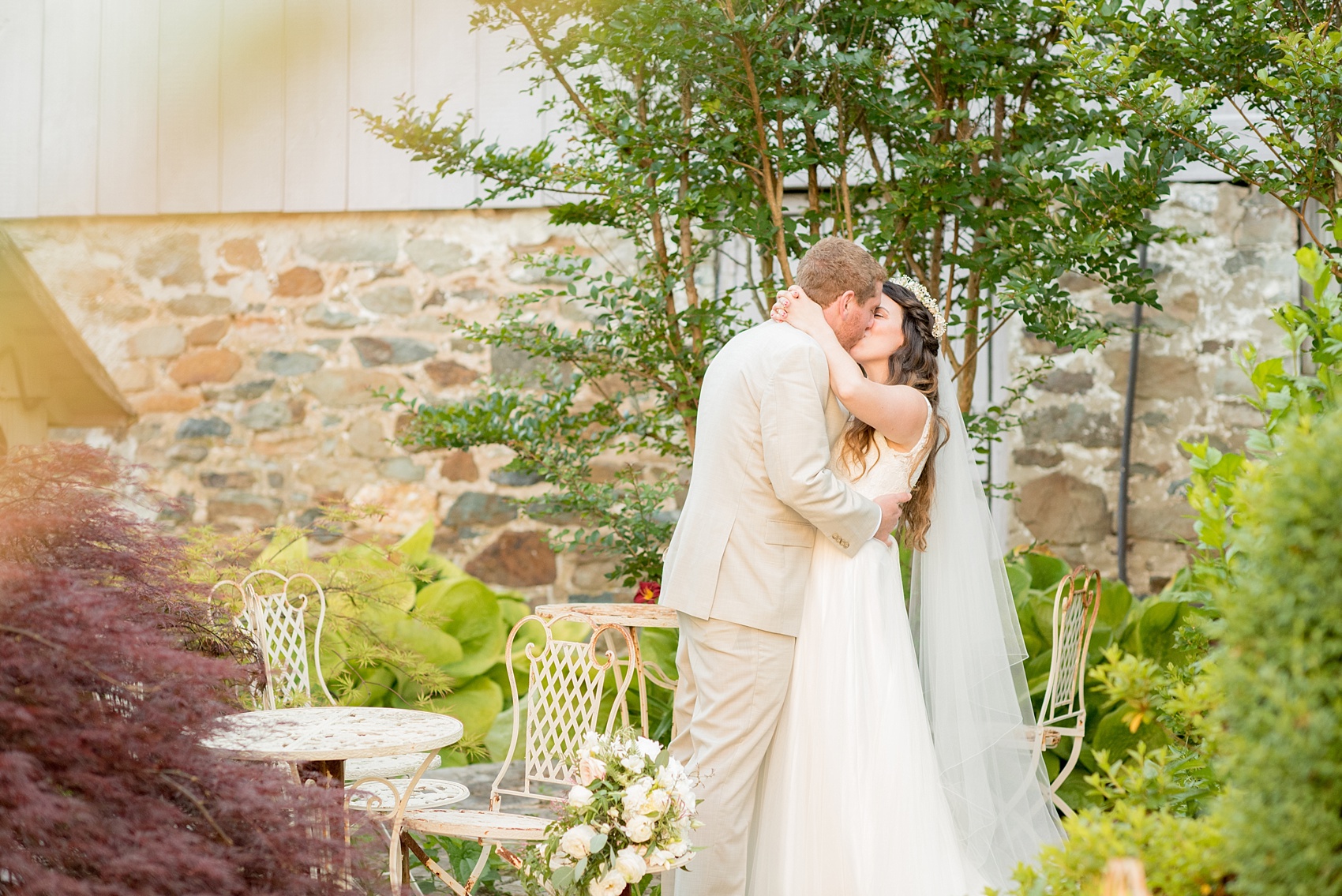 Mikkel Paige Photography photos of a wedding at Spring Hill Manor in Maryland. Image of the bride and groom kissing in the garden.