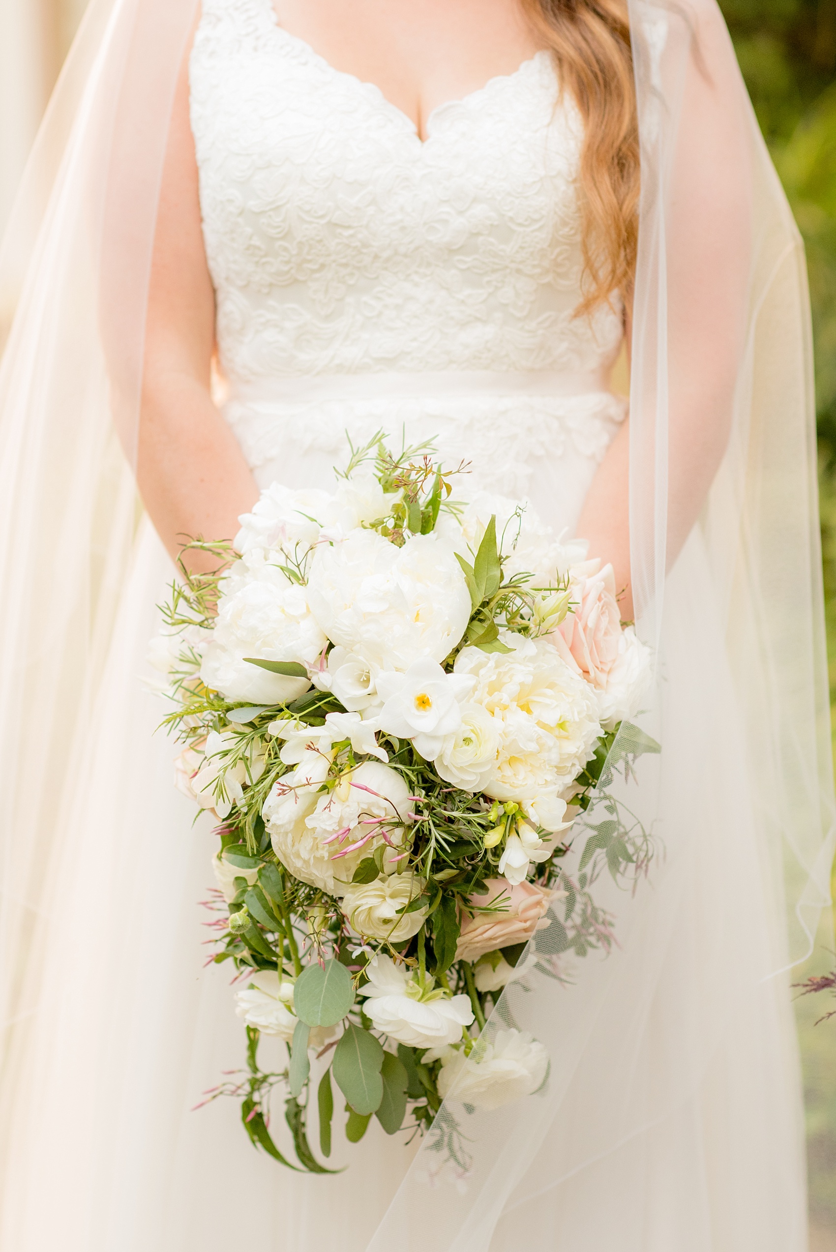 Mikkel Paige Photography photos of a wedding at Spring Hill Manor in Maryland. The bride's cascading bouquet with roses, peonies and ranunculus.