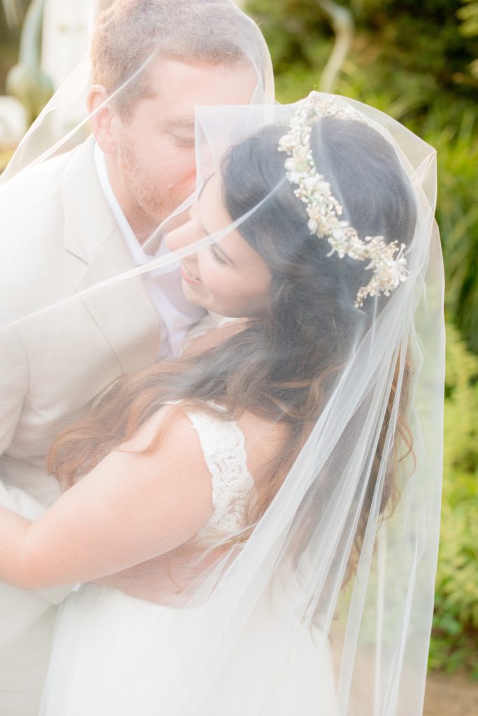 Mikkel Paige Photography photos of a wedding at Spring Hill Manor in Maryland. Image of the bride and groom with her floral crown in a Essence of Australia wedding gown and veil.