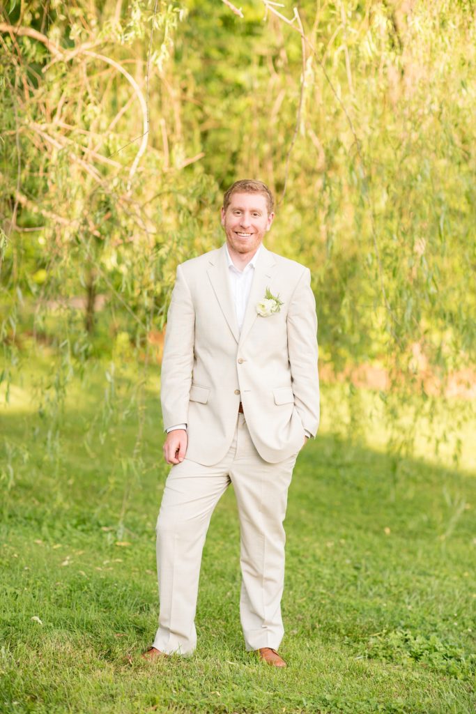 Mikkel Paige Photography photos of a wedding at Spring Hill Manor in Maryland. Image of the groom in his tan linen suit.