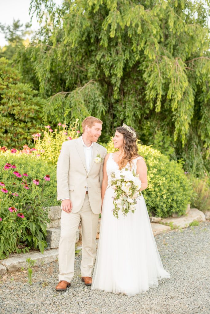 Mikkel Paige Photography photos of a wedding at Spring Hill Manor in Maryland. Bride and groom kiss near a Weeping Willow tree. Bride wore an Essence of Australia wedding gown.