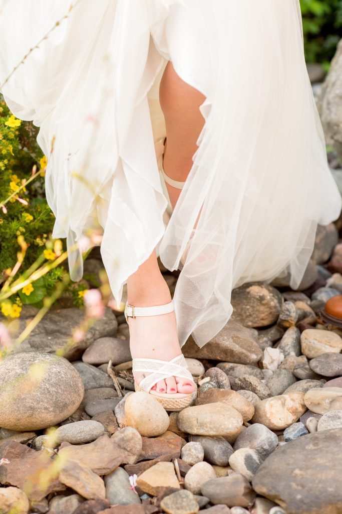 Mikkel Paige Photography photos of a wedding at Spring Hill Manor in Maryland. Image of the bride's white lace TOMS wedges.