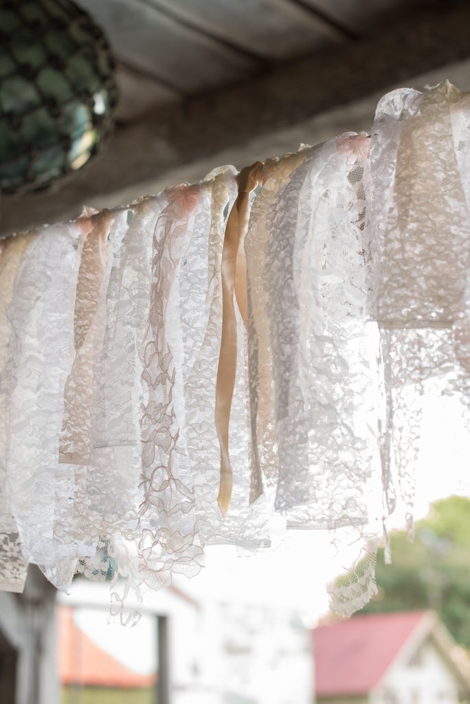 Mikkel Paige Photography photos of a wedding at Spring Hill Manor in Maryland. Image of the outdoor reception with rustic farm tables and lace garland.