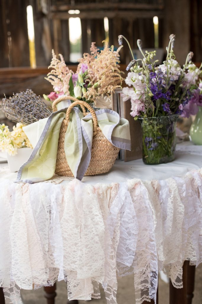 Mikkel Paige Photography photos of a wedding at Spring Hill Manor in Maryland. Image of rustic sweetheart table filled with lavender, freesia and lace garland decoration.