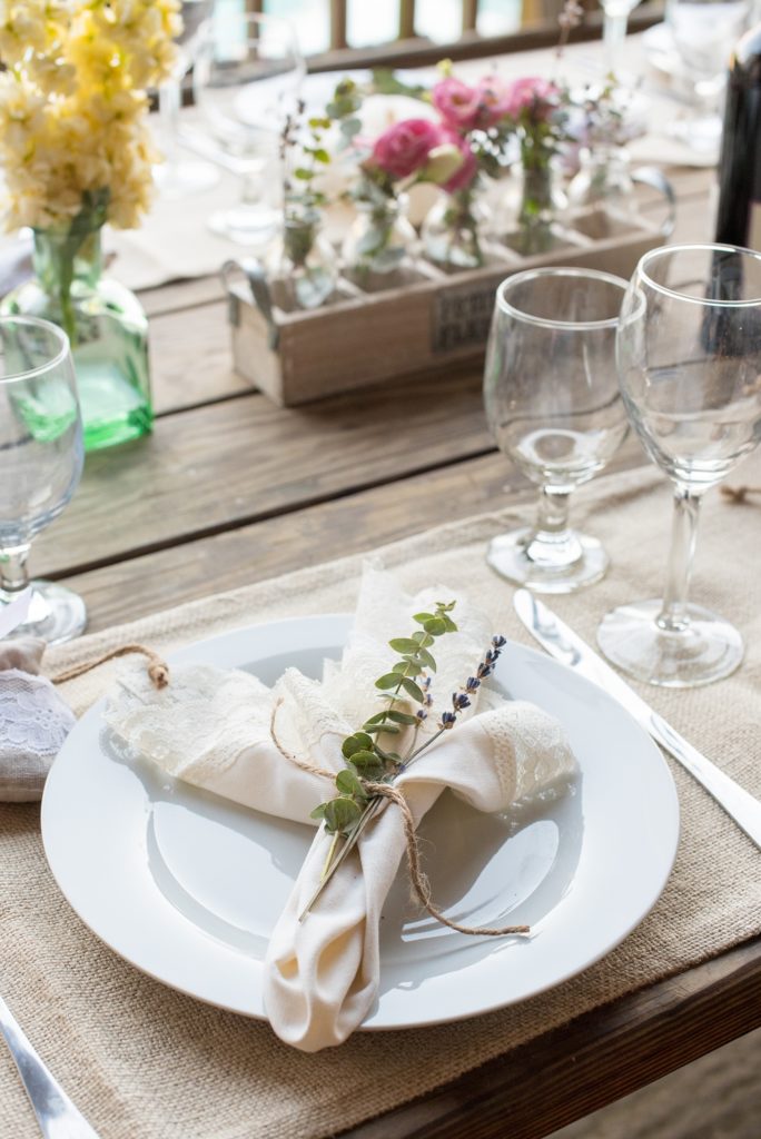 Mikkel Paige Photography photos of a wedding at Spring Hill Manor in Maryland. Image of rustic tables with napkins tied with jute and eucalyptus and lavender.