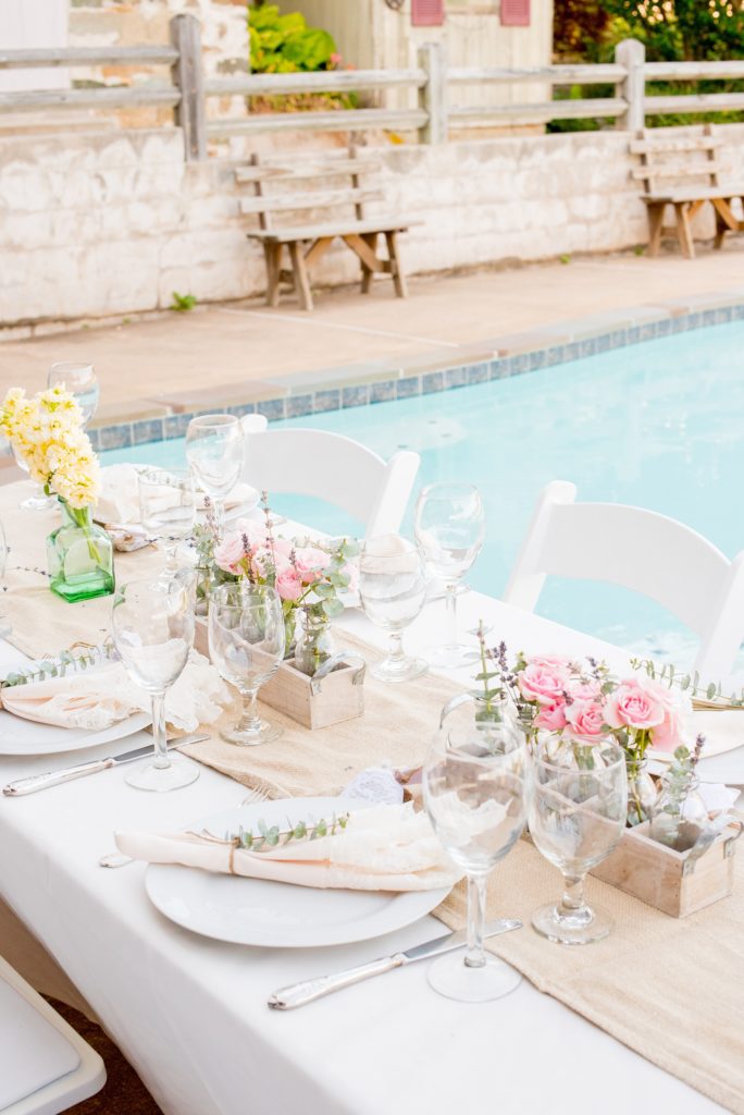 Mikkel Paige Photography photos of a wedding at Spring Hill Manor in Maryland. Image of rustic farm tables with bud vases and napkins tied with jute, eucalyptus and lavender.