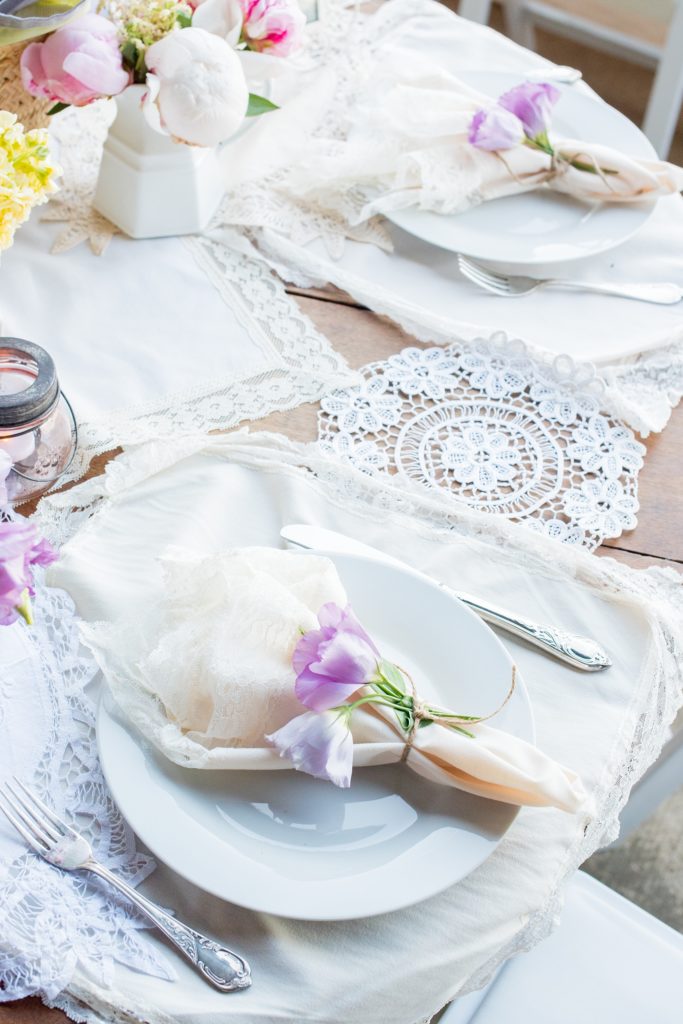 Mikkel Paige Photography photos of a wedding at Spring Hill Manor in Maryland. Image of rustic sweetheart table filled with lavender, freesia and lace garland decoration.