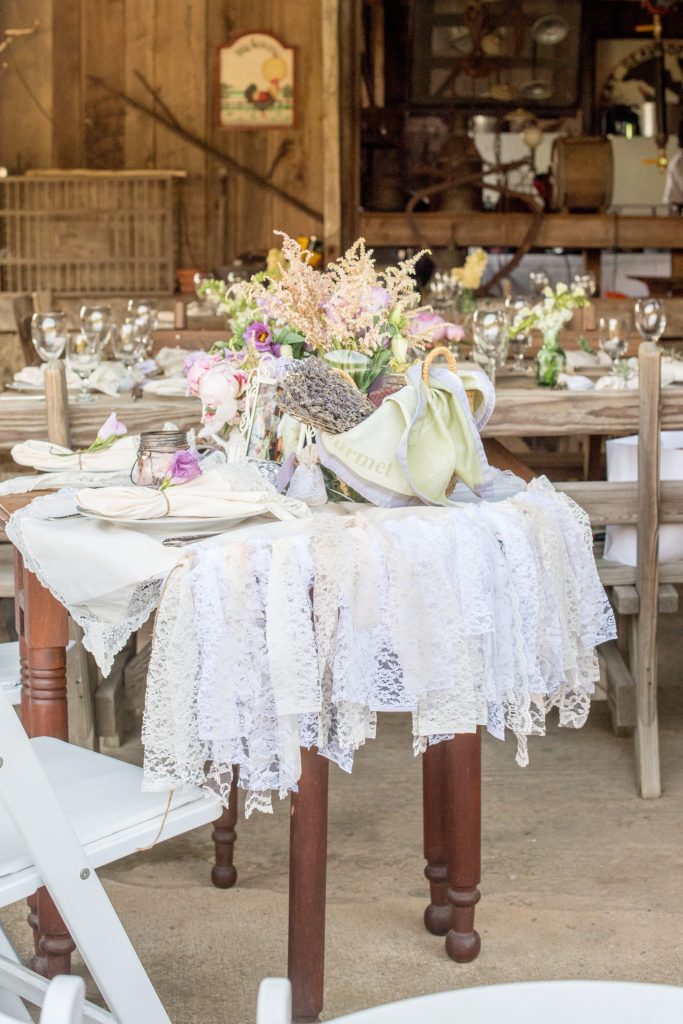 Mikkel Paige Photography photos of a wedding at Spring Hill Manor in Maryland. Image of rustic sweetheart table filled with lavender, freesia and lace garland decoration.