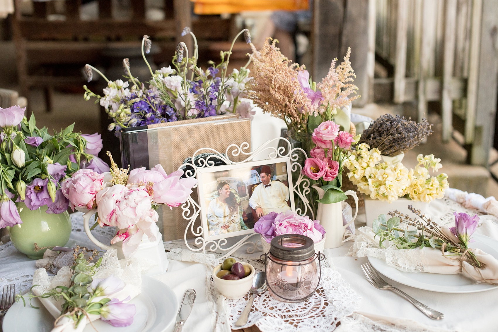 Mikkel Paige Photography photos of a wedding at Spring Hill Manor in Maryland. Image of rustic sweetheart table filled with lavender, freesia and lace garland decoration.