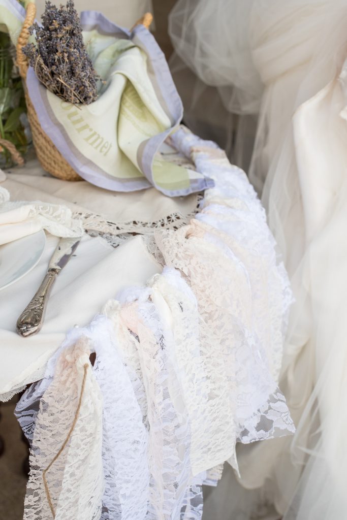 Mikkel Paige Photography photos of a wedding at Spring Hill Manor in Maryland. Image of rustic sweetheart table filled with lavender, freesia and lace garland decoration.