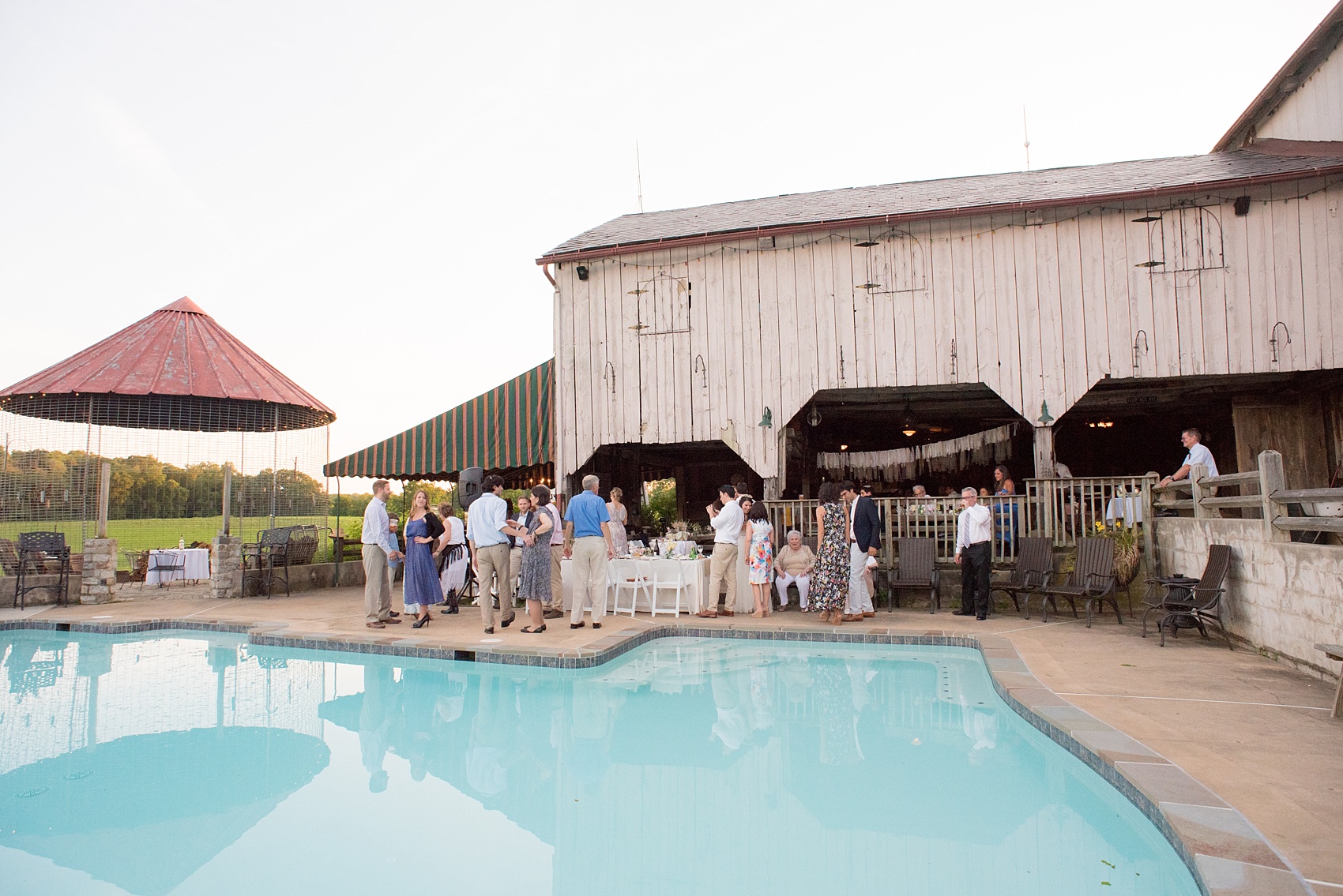 Mikkel Paige Photography photos of a wedding at Spring Hill Manor in Maryland. Image of the guests enjoying the outdoor pool areas.