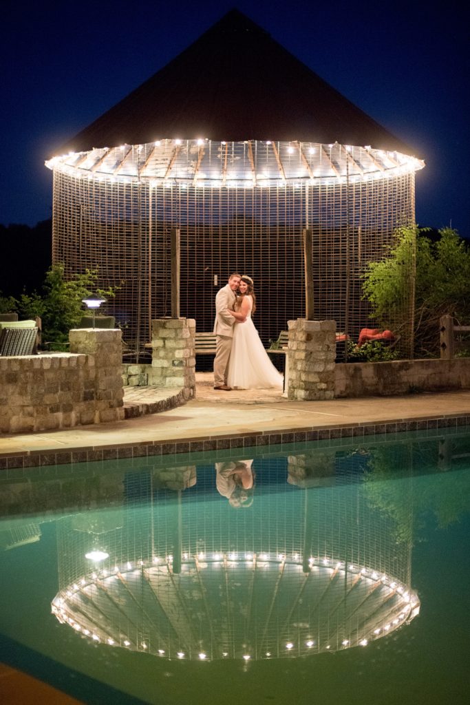 Mikkel Paige Photography photos of a wedding at Spring Hill Manor in Maryland. Night time image of the bride and groom by the pool with twinkle lights.