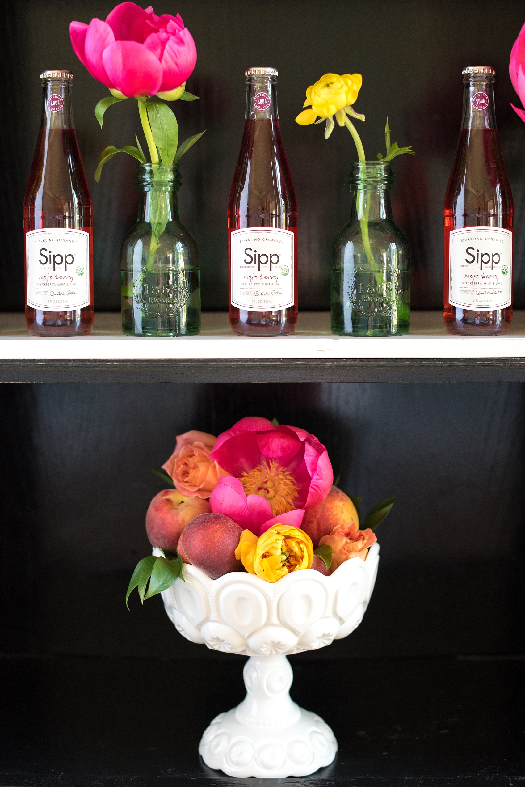 Mikkel Paige Photography wedding photo at The Bradford, NC. Drink bar with rose pink champagne and bud vases with yellow ranunculus and pink peonies and seasonal peaches.