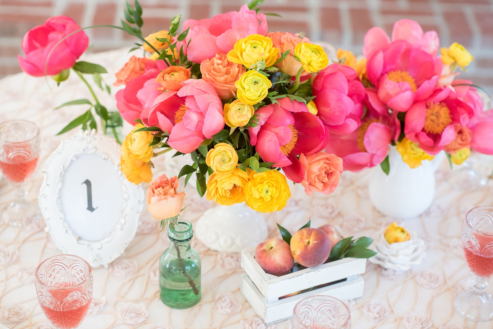 Mikkel Paige Photography wedding photo at The Bradford, NC. Modern pink, black and white table setup. Peonies and ranunculus and shabby chic peach holders.