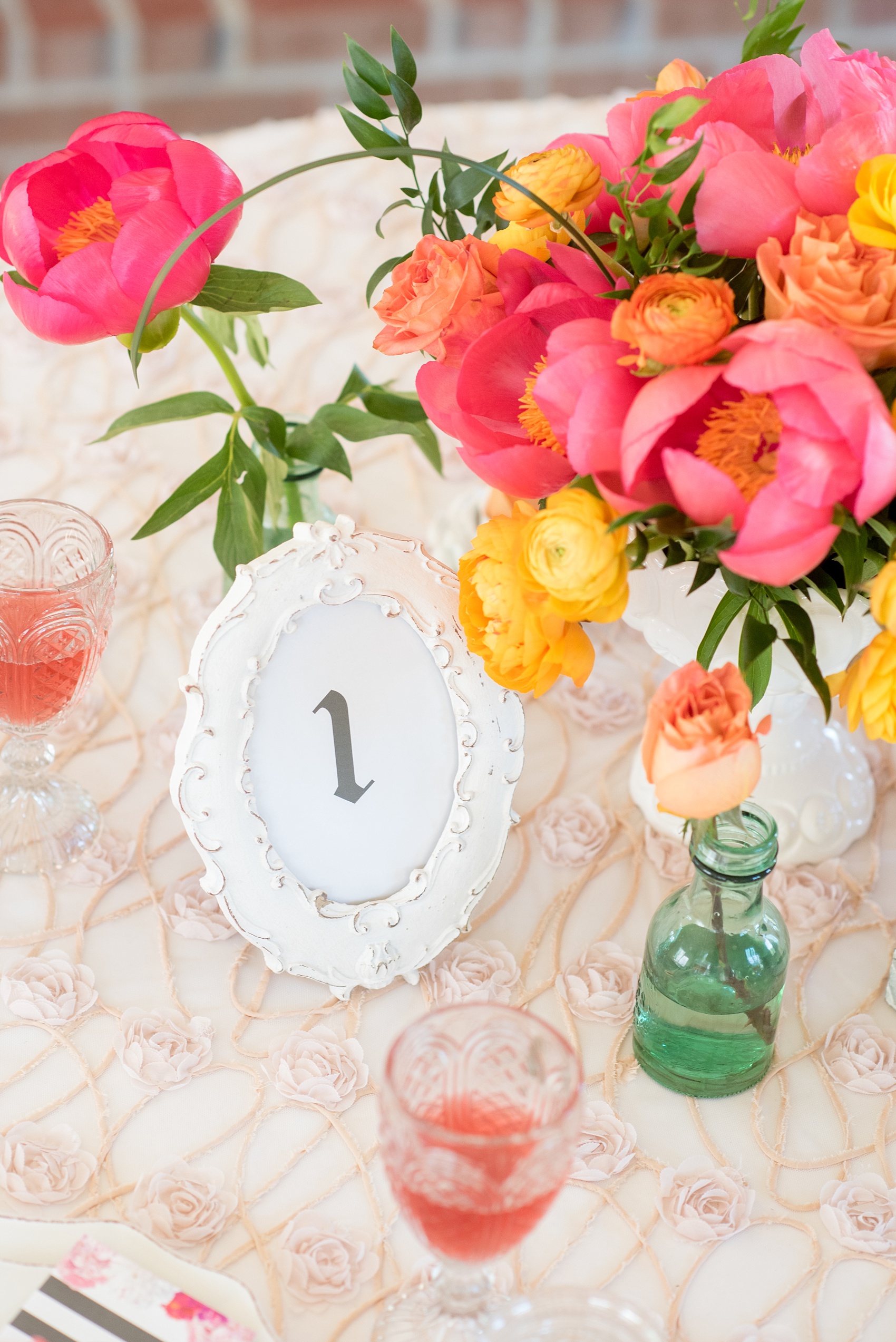 Mikkel Paige Photography wedding photo at The Bradford, NC. White shabby chic frame holds the table number.