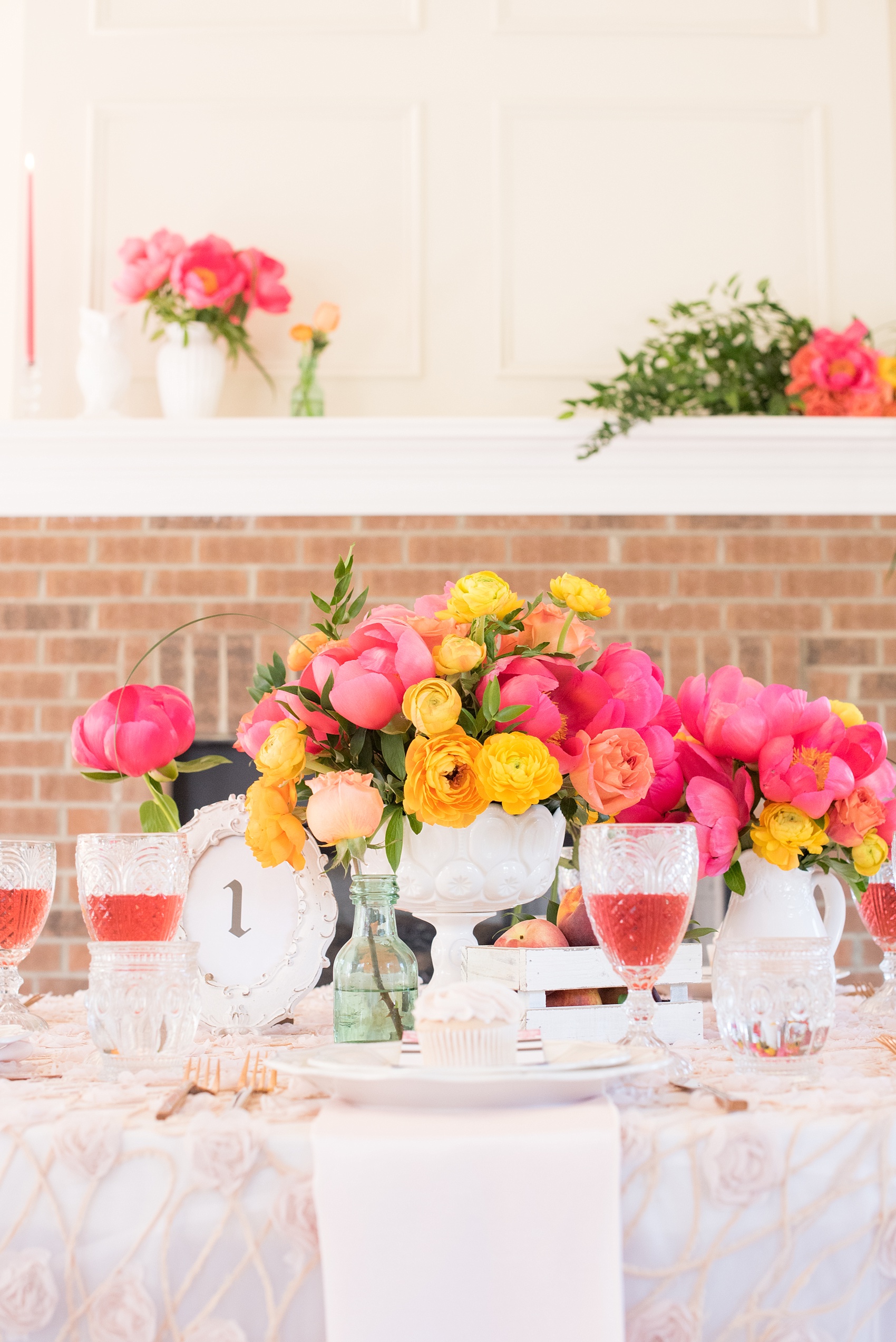 Mikkel Paige Photography wedding photo at The Bradford, NC. Modern pink, black and white table setup. Peonies and ranunculus and shabby chic peach holders.