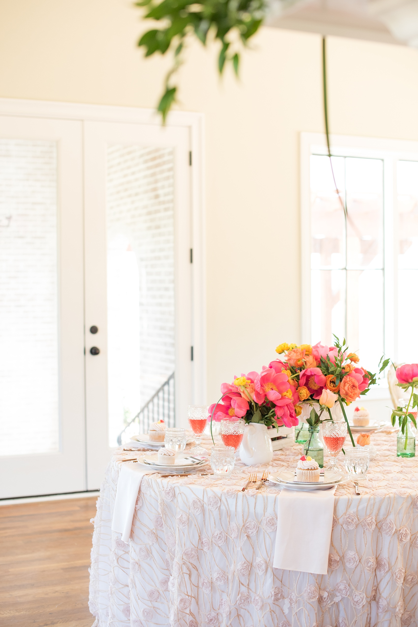 Mikkel Paige Photography wedding photo at The Bradford, NC. Modern pink, black and white table setup. Peonies and ranunculus and shabby chic peach holders.