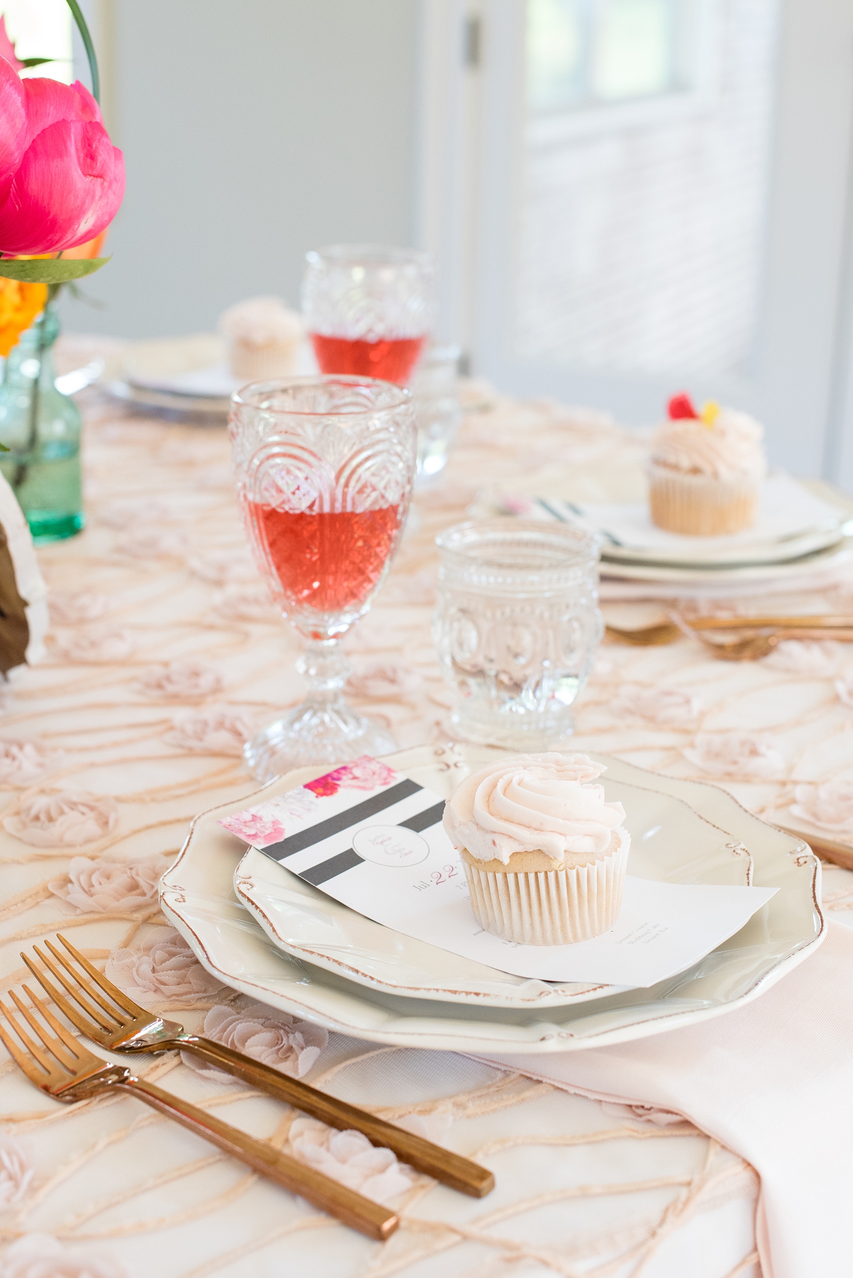 Mikkel Paige Photography wedding photo at The Bradford, NC. Modern pink, black and white table setup. Cupcake placed on top of the plate menu.