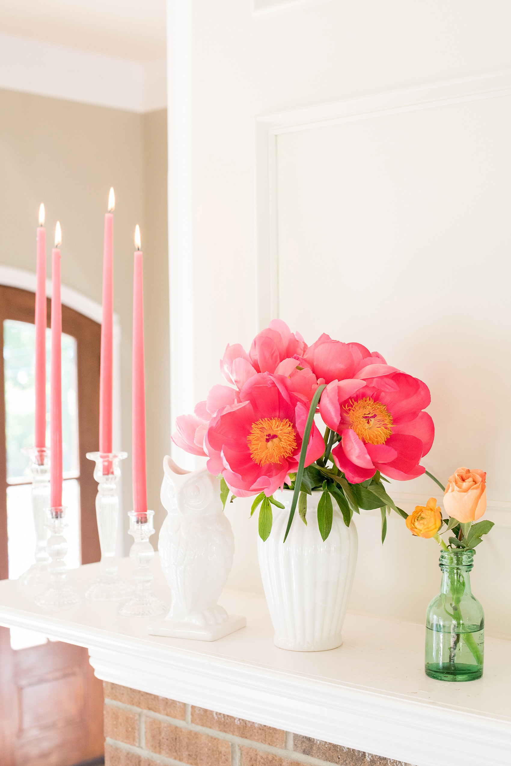 Mikkel Paige Photography wedding photo at The Bradford, NC. Pink candles and peonies adorn the fireplace mantle.