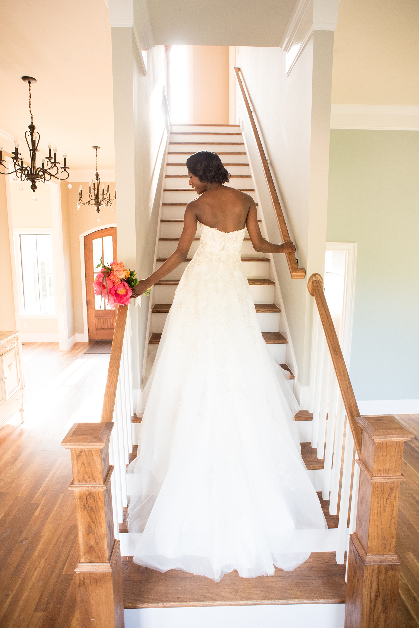 Mikkel Paige Photography photo at The Bradford, NC. Bride poses on the staircase inside the elegant NC home.