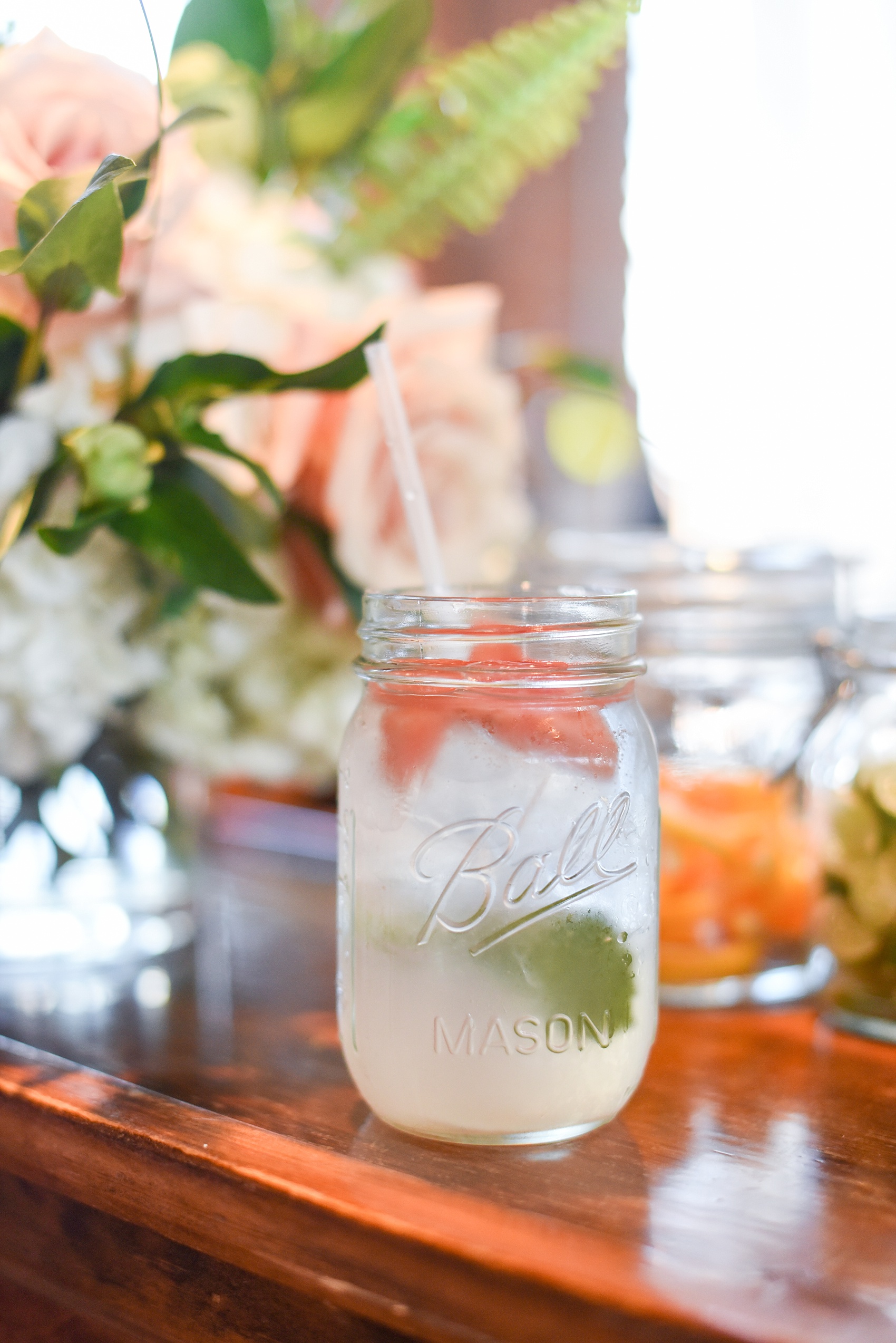 Mikkel Paige Photography photos from The Cotton Room wedding venue in Durham, NC. The bar served hand crafted watermelon and cucumber cocktails in mason jars.