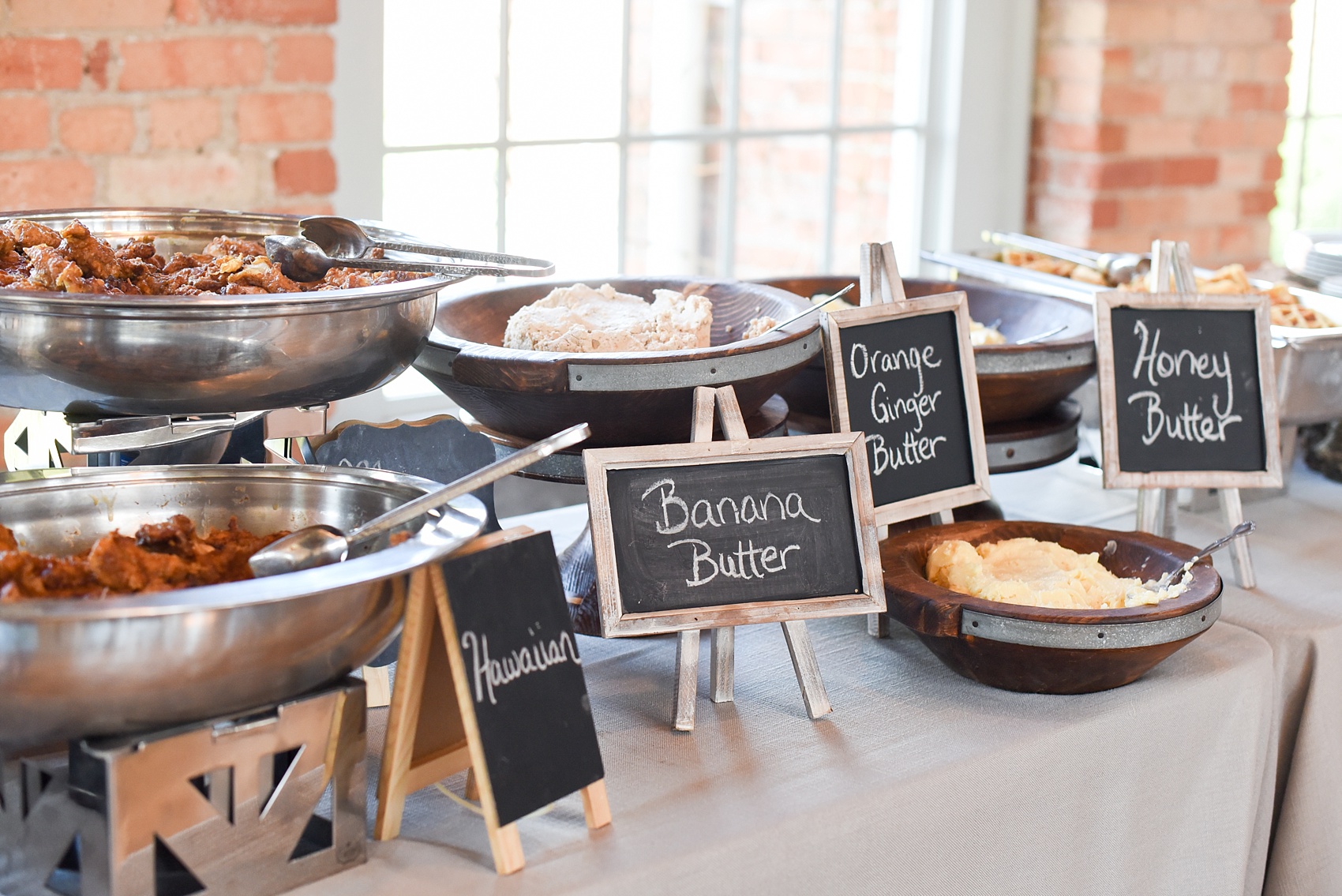 Mikkel Paige Photography image from The Cotton Room wedding venue in Durham, NC. A chicken and waffles bar was complete with three different flavors of butter.