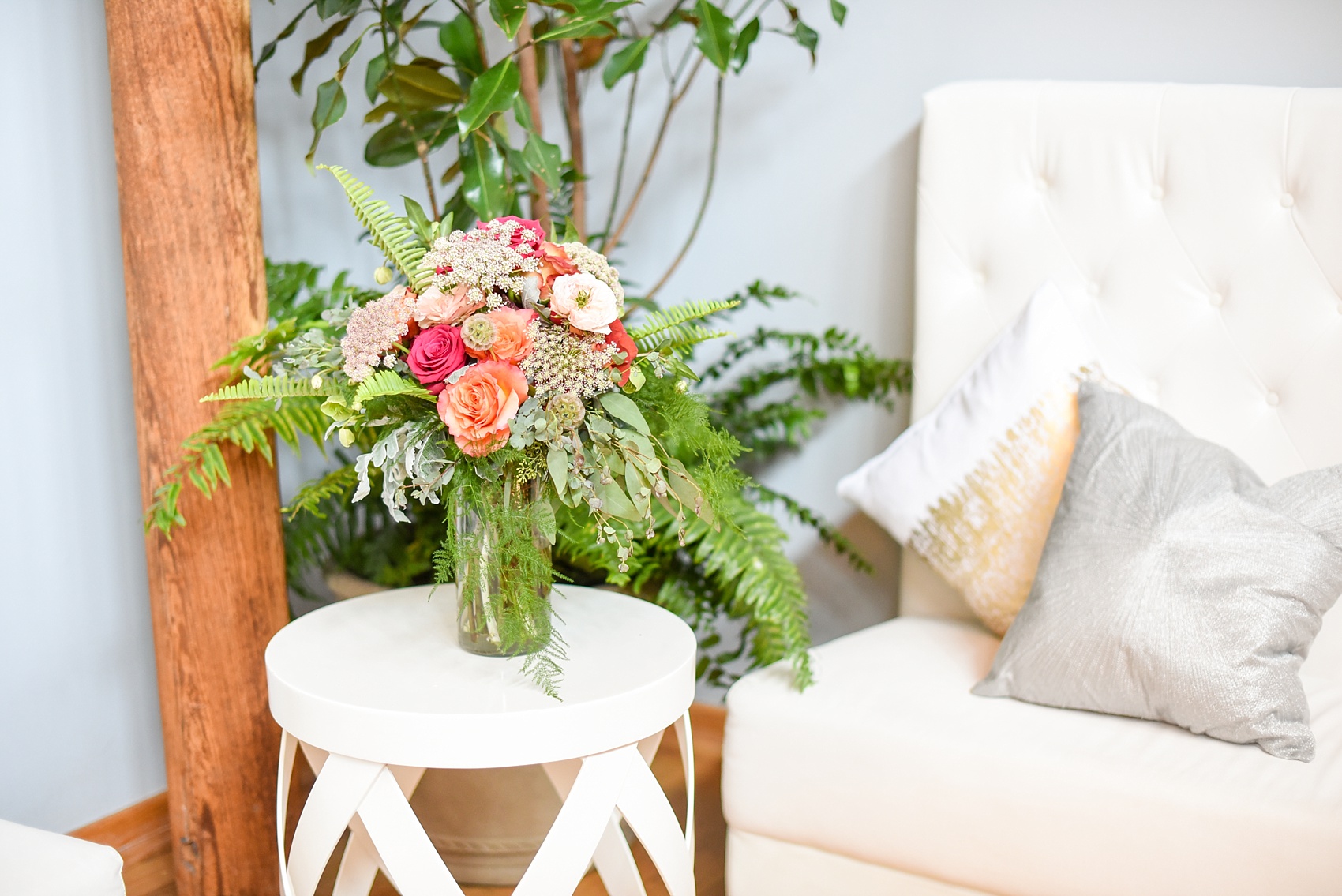 Mikkel Paige Photography image from The Cotton Room wedding venue in Durham, NC. Fresh fern and rose floral arrangements decorated the space.