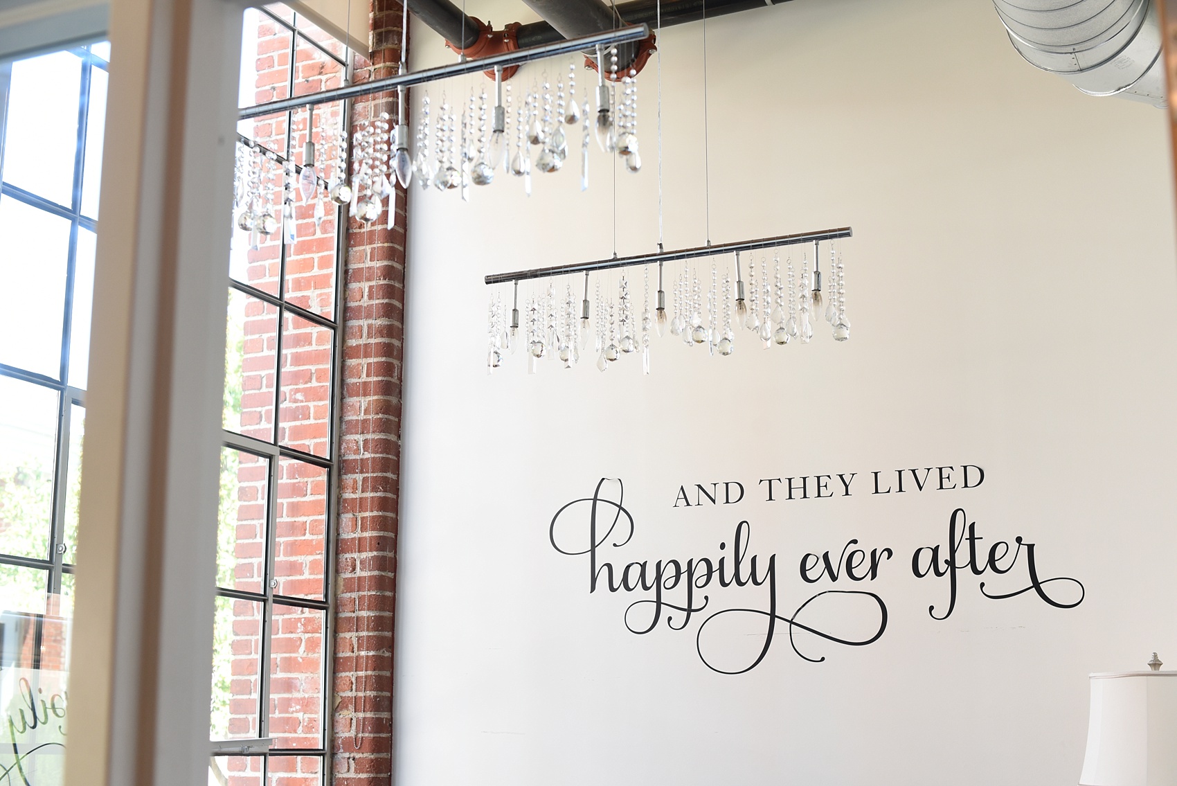 Mikkel Paige Photography photos from The Cotton Room wedding venue in Durham, NC. A Happily Ever After decal adorns the bridal suite wall.