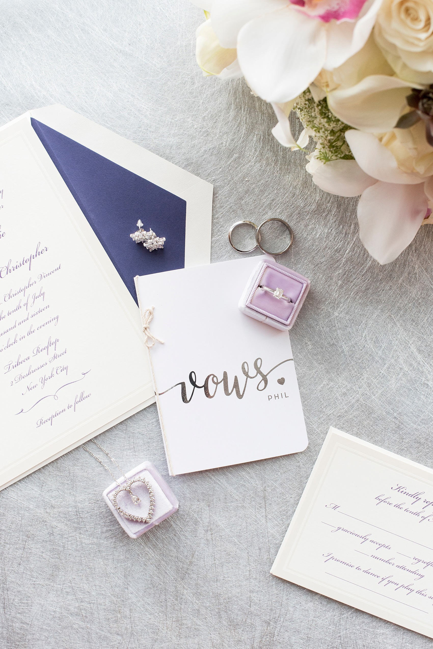 Mikkel Paige Photography photos of a NYC wedding at Tribeca Rooftop. Image of the Mrs. Box in purple and vows book and invitation.