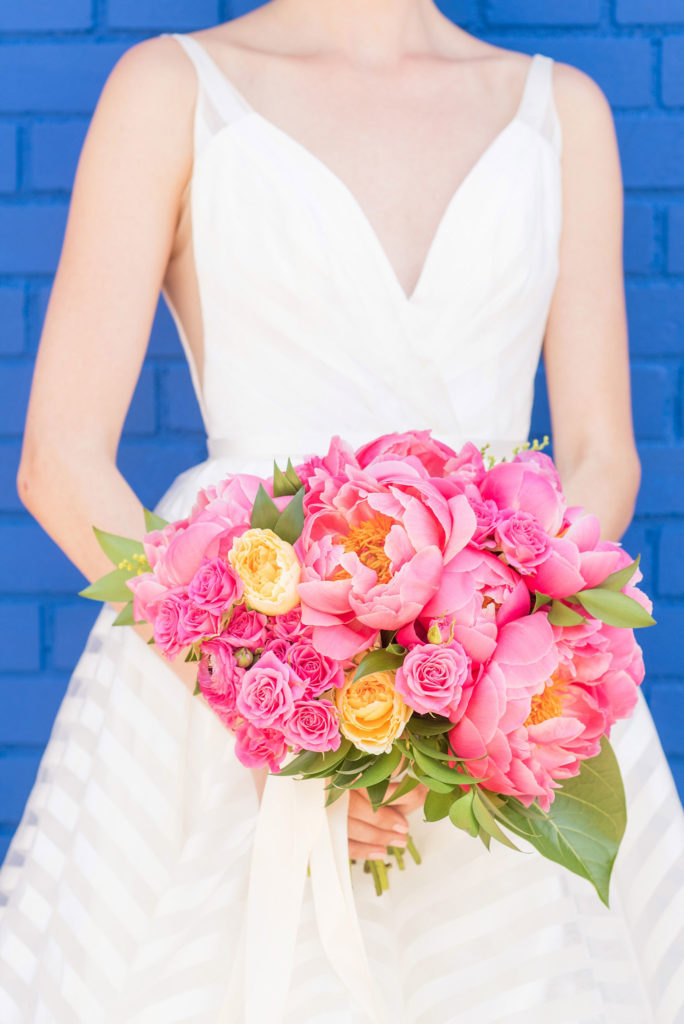 Mikkel Paige Photography photo of Dobbin St Brooklyn wedding. Planning and coordination by Color Pop Events with a peony and ranunculus bouquet by Blade NYC and striped white gown by Hayley Paige.