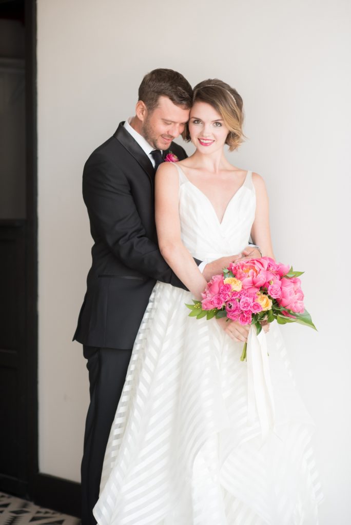 Mikkel Paige Photography photo of Dobbin St Brooklyn wedding. Planning and coordination by Color Pop Events. Bride in Hayley Paige white striped gown with short hair do with headband detail. Peony and ranunculus bouquet by Blade NYC.