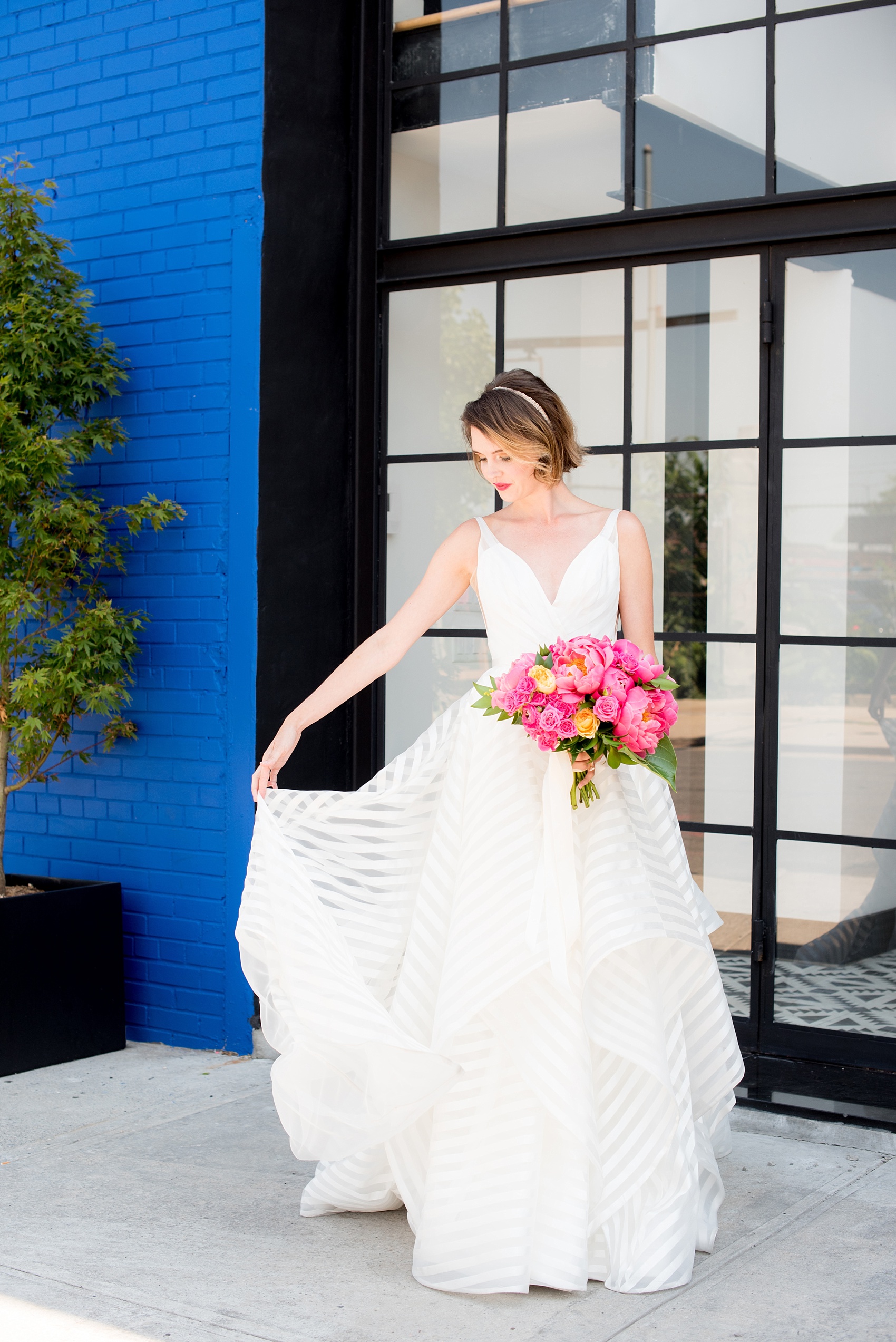 Mikkel Paige Photography photo of Dobbin St Brooklyn wedding. Planning and coordination by Color Pop Events. Bride in Hayley Paige white striped gown with short hair do with headband detail. Peony and ranunculus bouquet by Blade NYC.