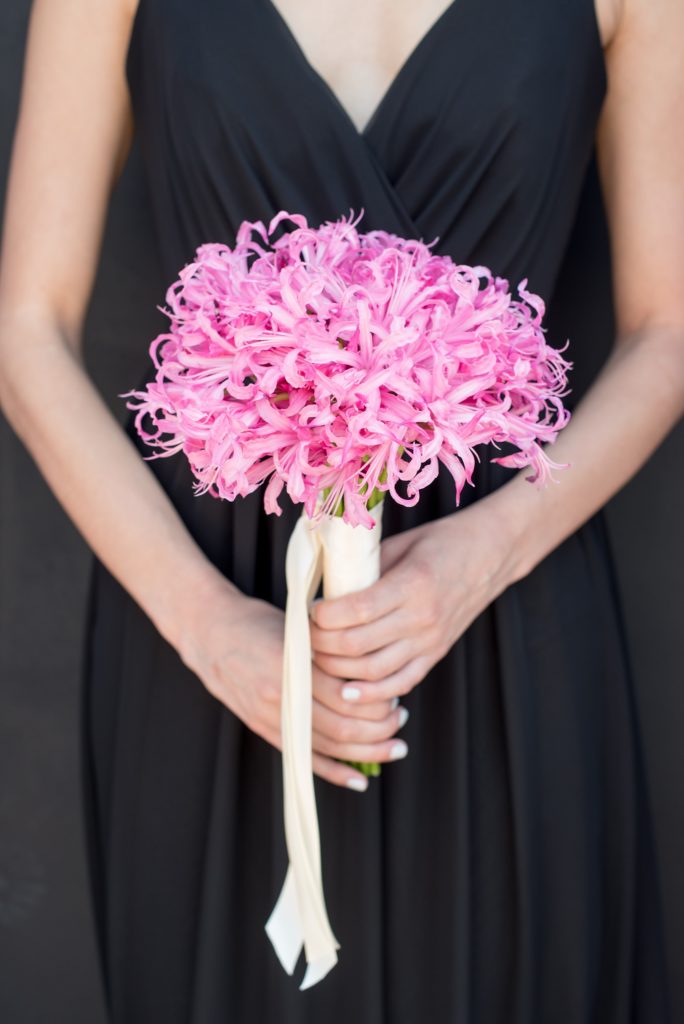 Mikkel Paige Photography captures a wedding at Dobbin St in Brooklyn, NY. Planning by Color Pop Events and pink single flower bouquet by Blade NYC.