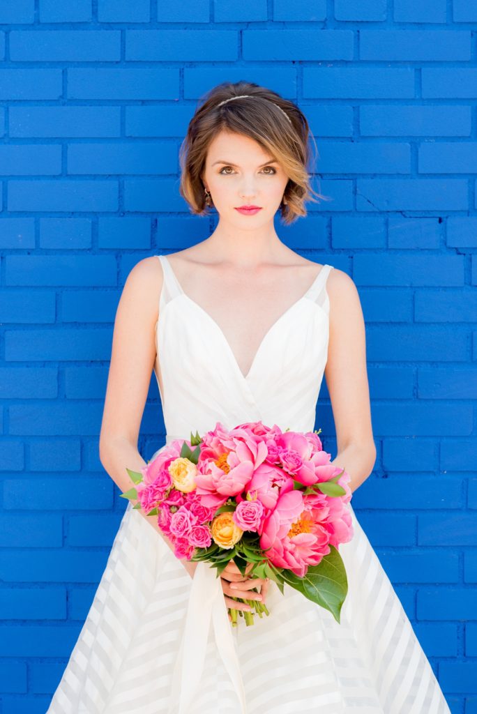 Mikkel Paige Photography photo of Dobbin St Brooklyn wedding. Planning and coordination by Color Pop Events. Bride in Hayley Paige white striped gown with short hair do with headband detail. Peony and ranunculus bouquet by Blade NYC.