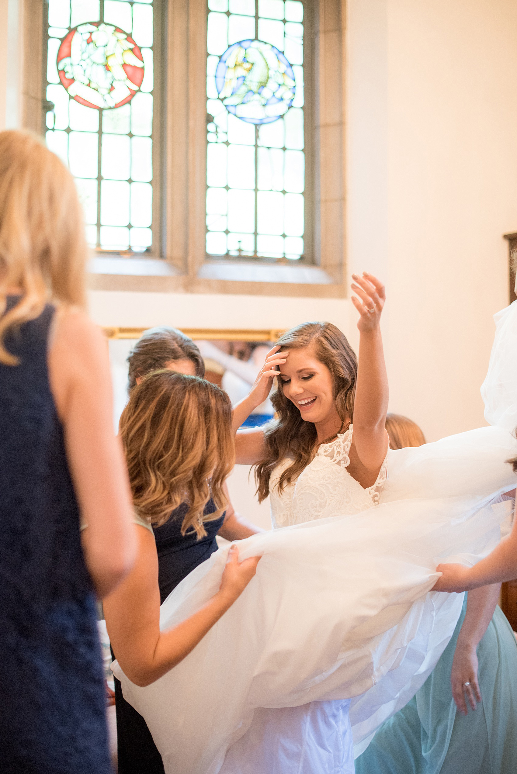 Mikkel Paige Photography photo of a Duke Chapel wedding in Durham, North Carolina with the bride getting dressed in her wedding gown.