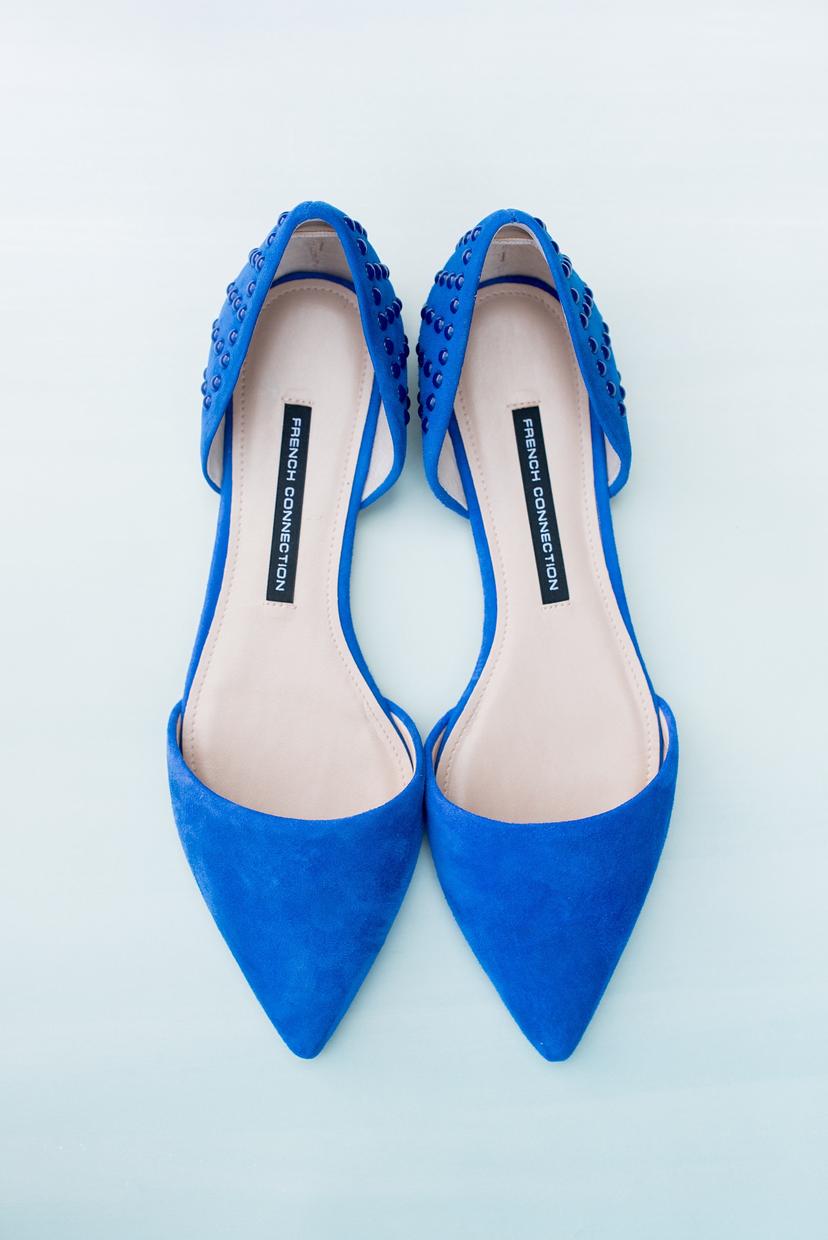 Mikkel Paige Photography photo of a Duke Chapel wedding in Durham, North Carolina with the bride's royal blue flat shoes. 