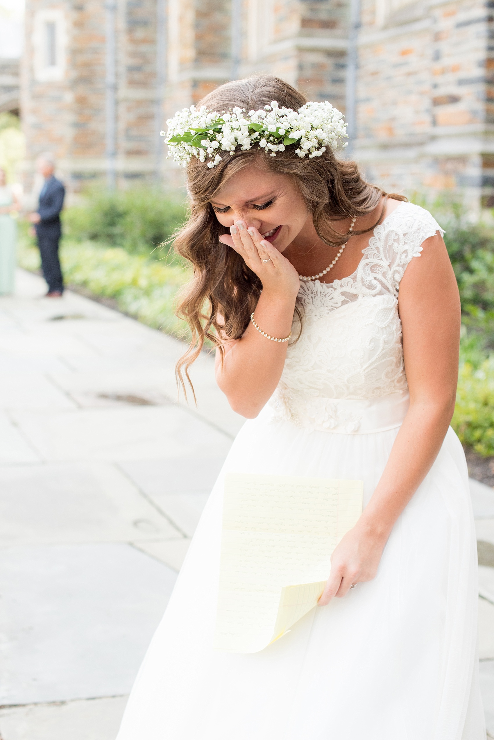 Mikkel Paige Photography photo of a Duke Chapel wedding in Durham, North Carolina. The bride, in a flower crown, reads a letter from her groom before the ceremony.