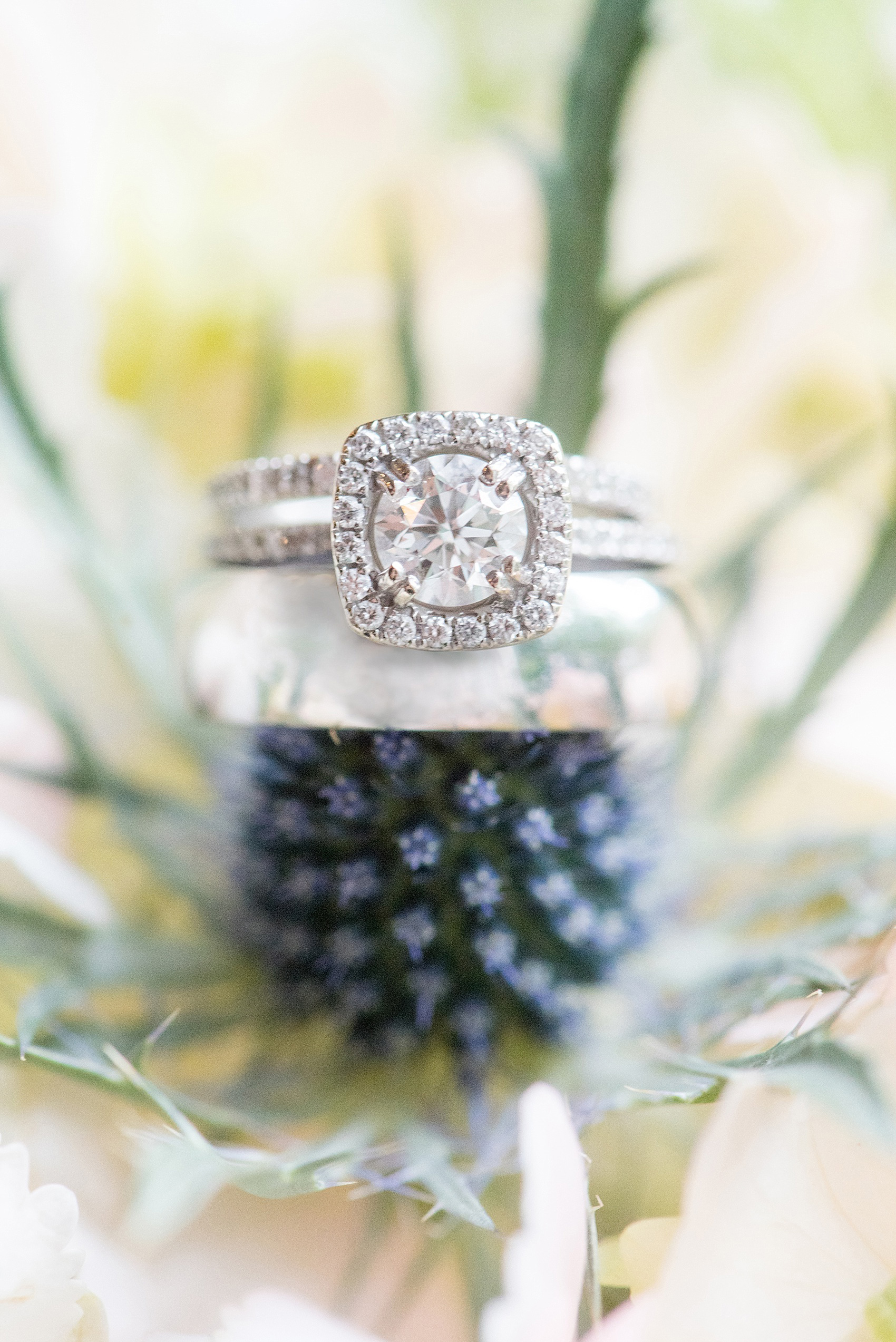 Mikkel Paige Photography photo of a Duke Chapel wedding in Durham, North Carolina. A detail image of the wedding bands and halo diamond engagement ring.