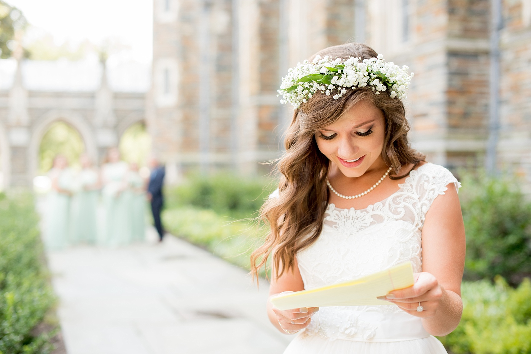 Mikkel Paige Photography photo of a Duke Chapel wedding in Durham, North Carolina. The bride, in a flower crown, reads a letter from her groom before the ceremony.