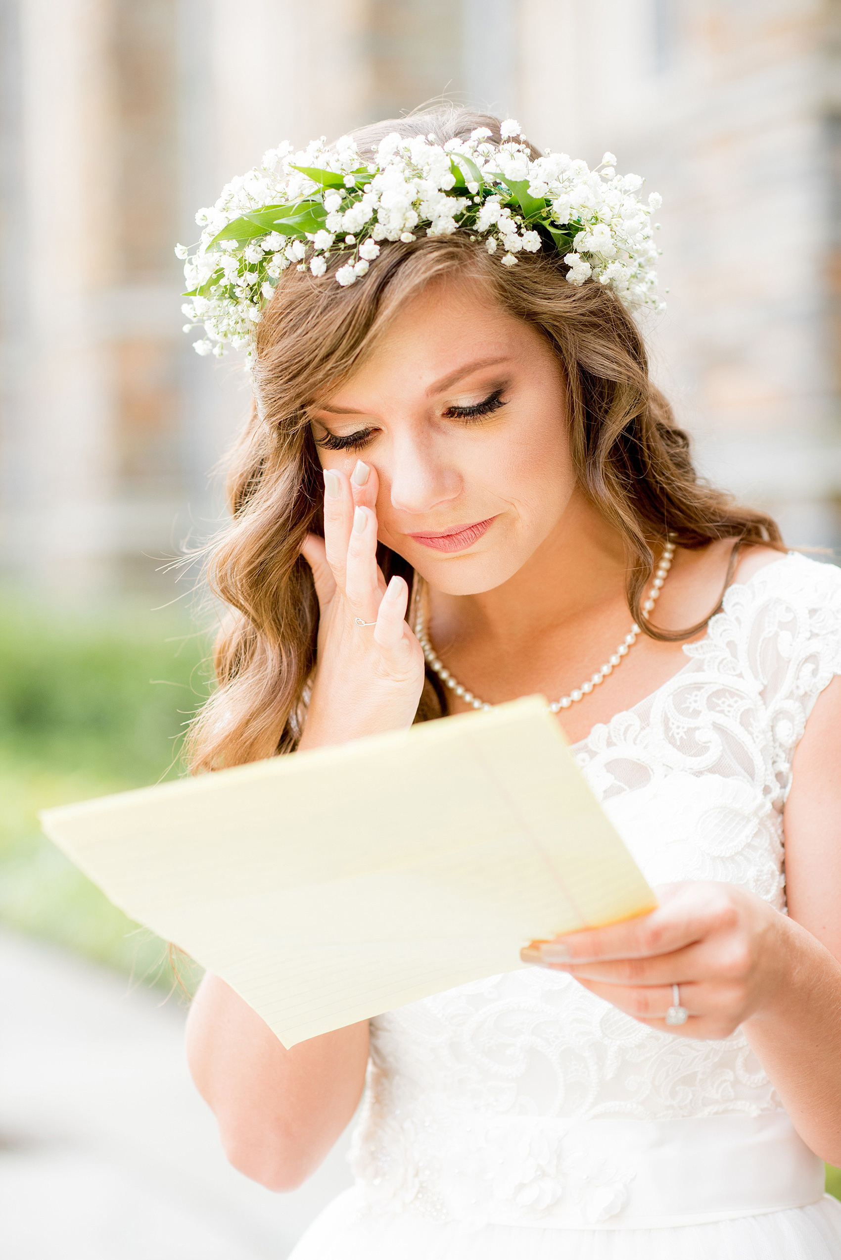 Mikkel Paige Photography photo of a Duke Chapel wedding in Durham, North Carolina. The bride, in a flower crown, reads a letter from her groom before the ceremony.
