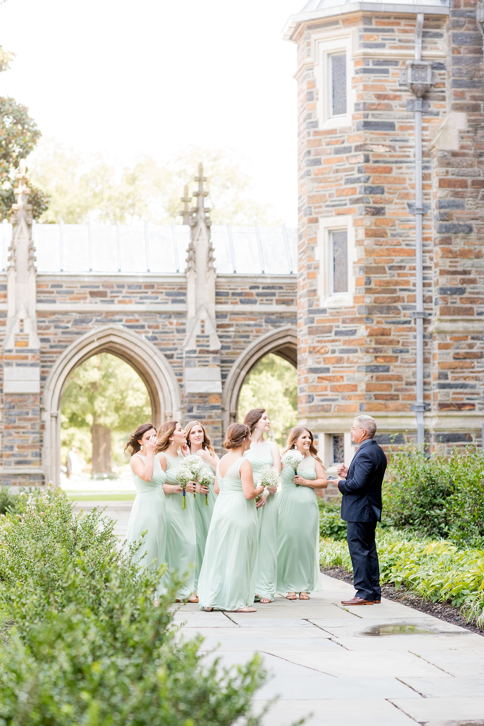 Mikkel Paige Photography photo of a Duke Chapel wedding in Durham, North Carolina. The bridesmaids and father of the bride wait for the ceremony to begin.