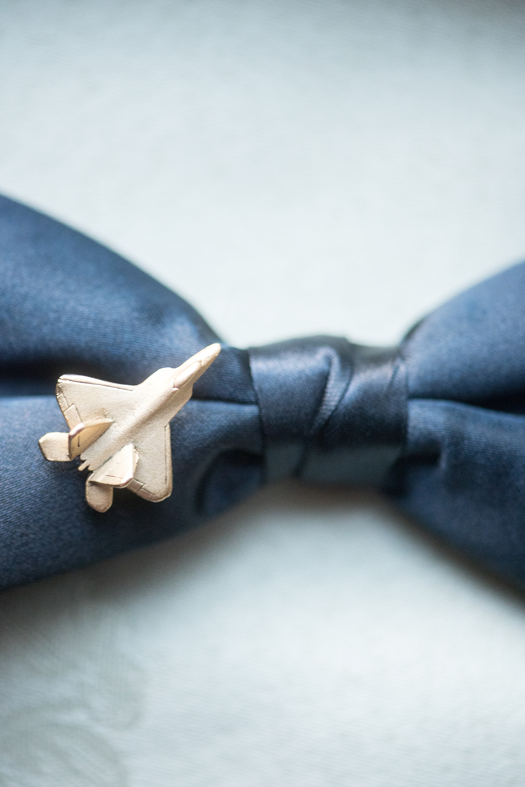 Mikkel Paige Photography photo of a Duke Chapel wedding in Durham, North Carolina. The groom's navy blue bow tie and air force pin.