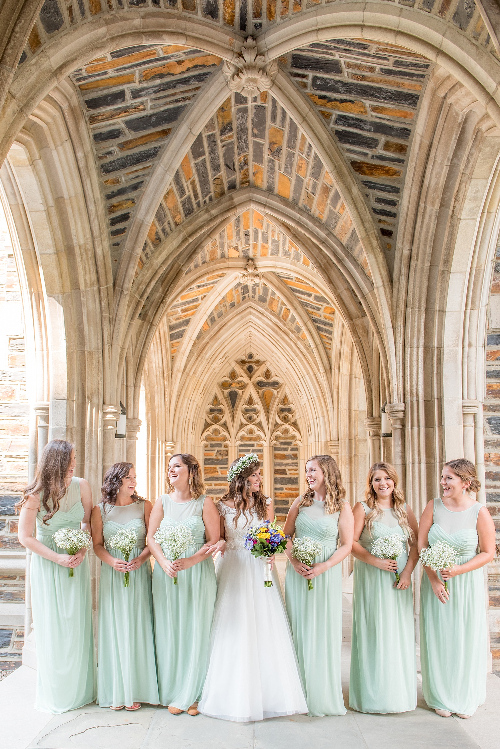 Mikkel Paige Photography photo of a Duke Chapel wedding in Durham, North Carolina. The bride and her bridesmaids mint green gowns under the gothic arches of the iconic church.