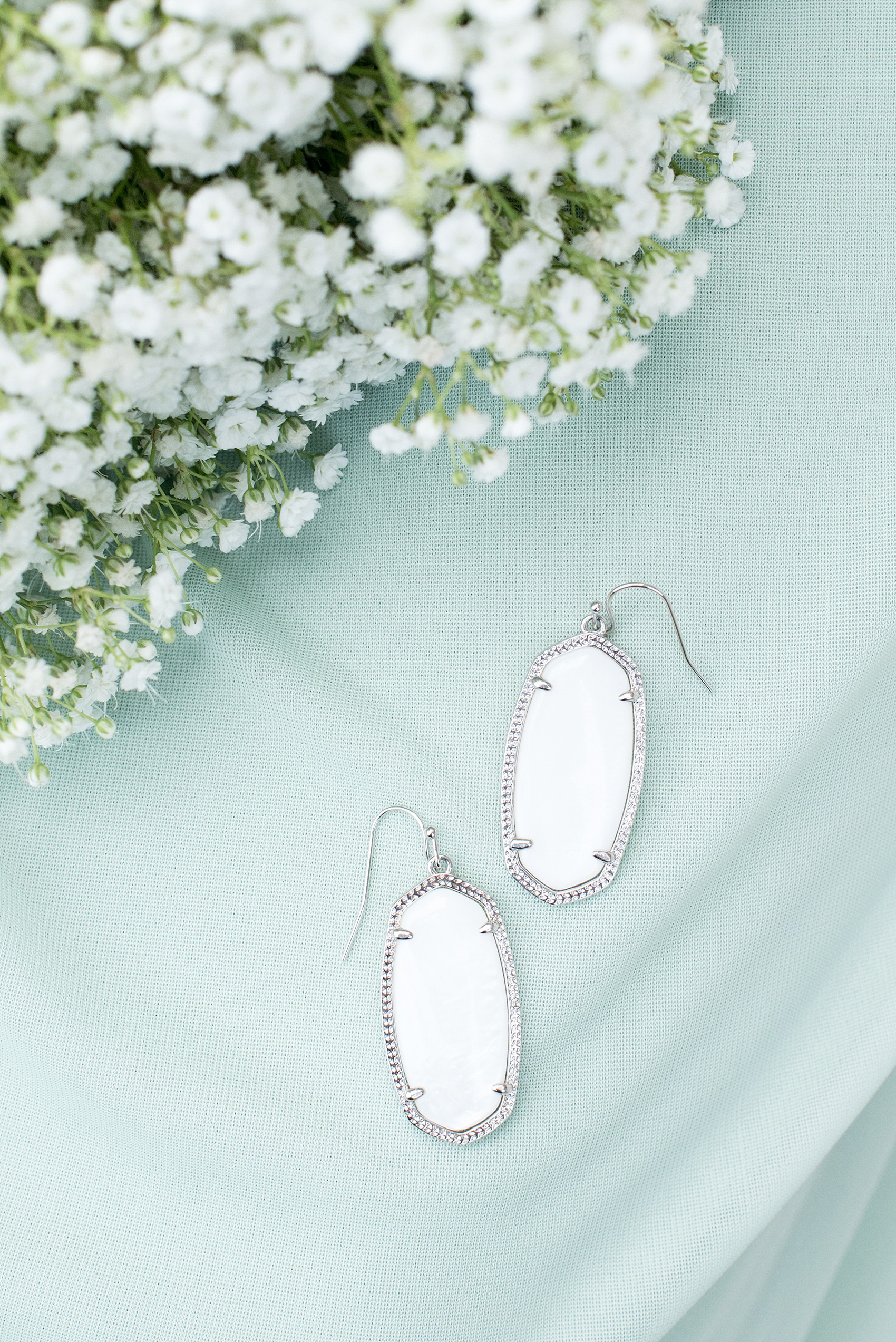 Mikkel Paige Photography photo of a Duke Chapel wedding in Durham, North Carolina. White Kendra Scott earrings for the bridesamaids gifts. 