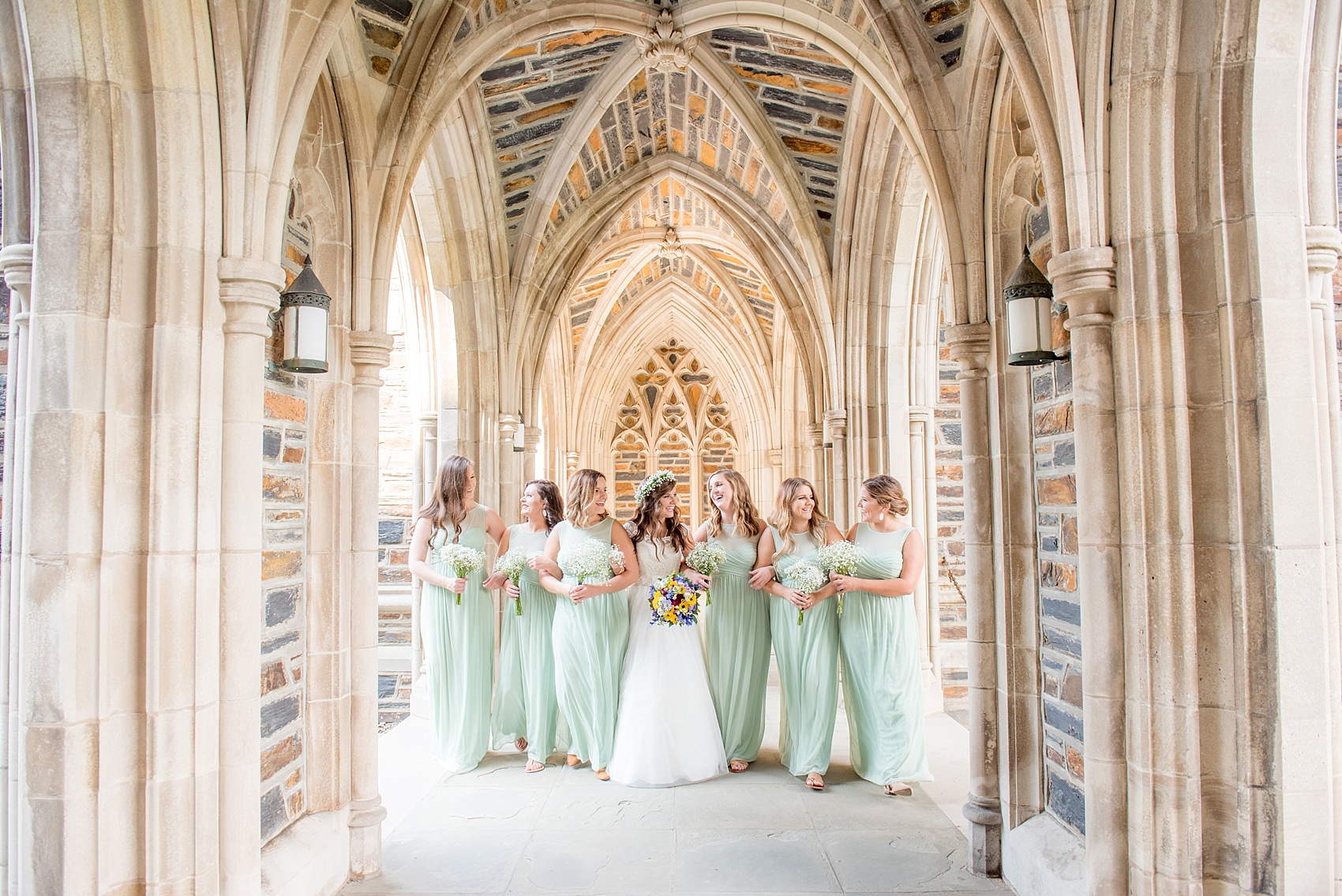 Mikkel Paige Photography photo of a Duke Chapel wedding in Durham, North Carolina. The bride and her bridesmaids mint green gowns under the gothic arches of the iconic church.